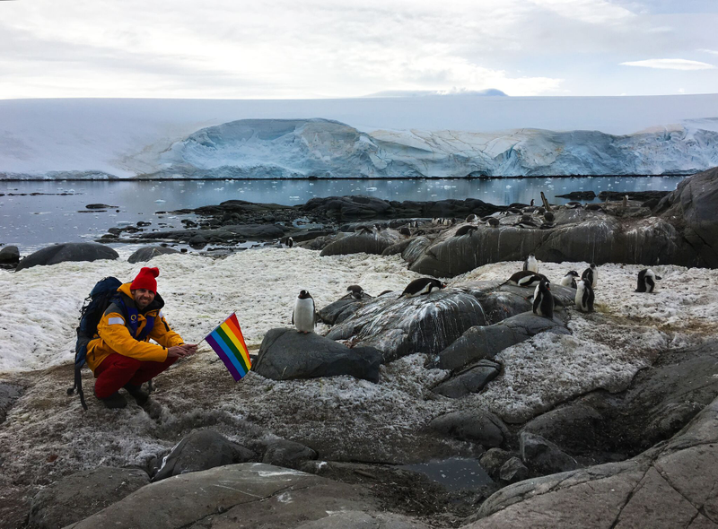 Aaron Jackson raising the rainbow flag with his (potentially gay?) penguin friends.